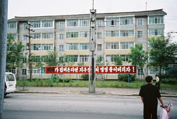 朝鮮民主主義人民共和国・DMZ「2005年金正日政権下の北朝鮮」の写真：駅前にはこんなスローガン。
反米な意味ら...